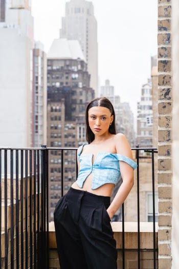 Woman in Blue Sleeveless Top and Black Skirt Standing Near Black Metal Fence · Free Stock Photo