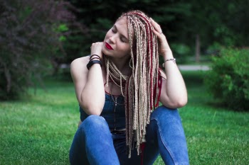Woman in Blue Sleeveless Top and Blue Jeans