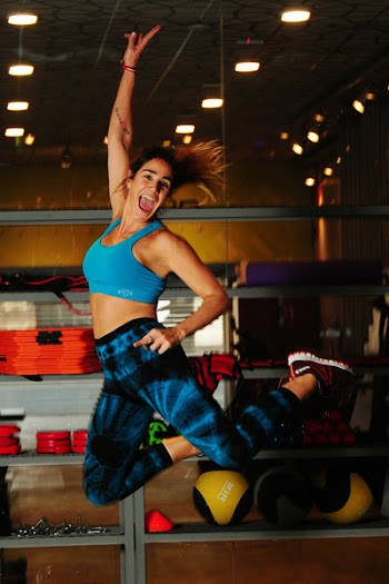 Woman in Blue Sports Bra Jumping Photo