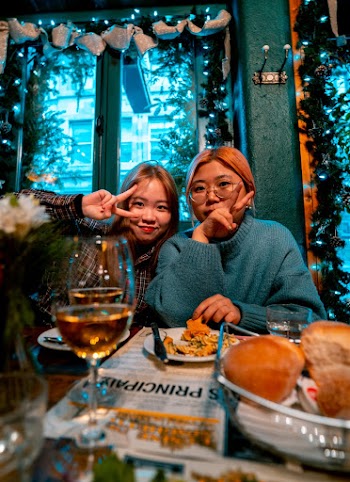 Woman in Blue Sweater in Front of Table