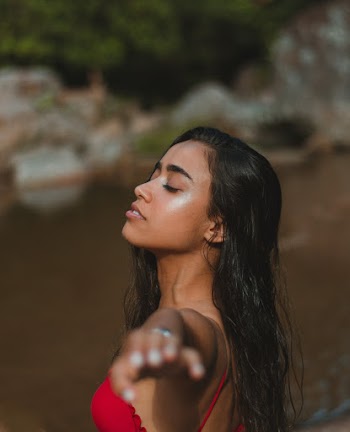 Woman in Blue Swimwear Meditating at the Beach