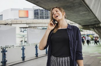 Woman in Blue Top Speaking on Phone