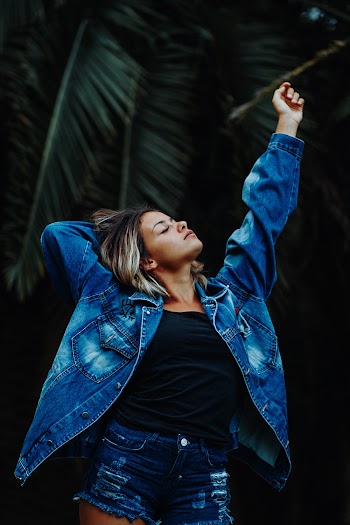 Woman In Blue-washed Denim Jacket And Distressed Denim Short Shorts