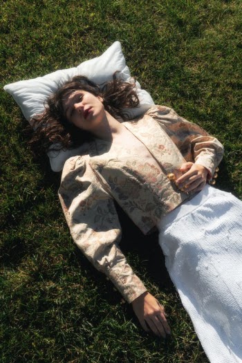 Woman in Brown and Beige Camouflage Jacket Lying on Green Grass · Free Stock Photo