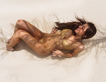 Woman in Brown Bikini Lying on White Sand