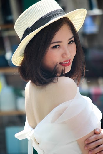 Woman In Brown Fedora Hat And White Off-shoulder Dress