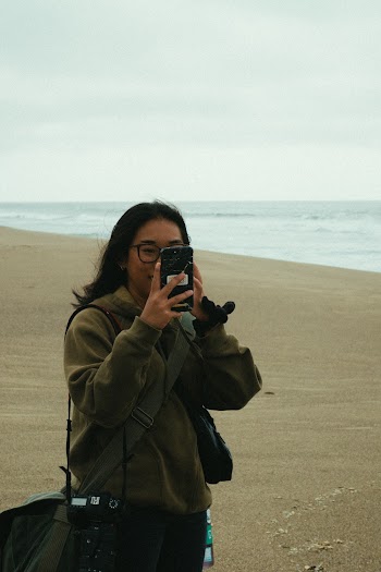Woman in Brown Hooded Jacket Holding Android Smartphone