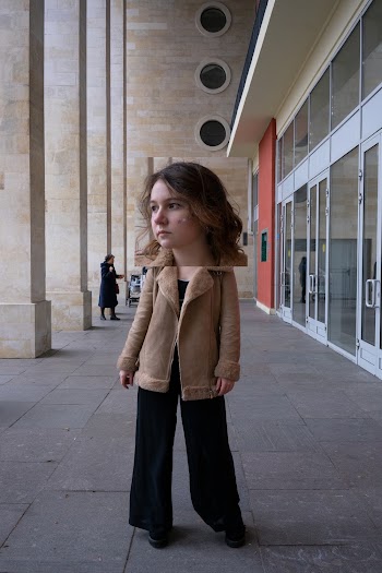 Woman in Brown Jacket and Black Pants