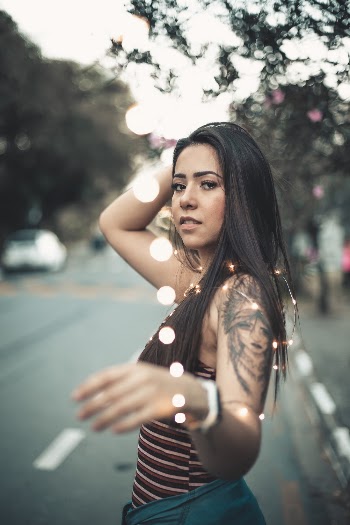 Woman in Brown Striped Tank Top Stands Beside Road