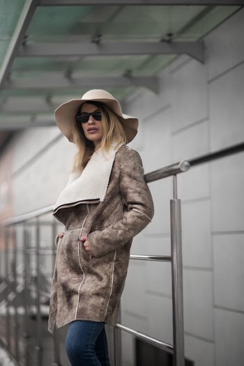 Woman in Brown Suede Coat and Sun Hat