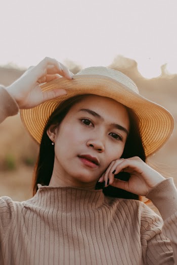 Woman In Brown Sun Hat And Turtleneck Sweater