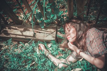 Woman in Brown Top Lying on Garden