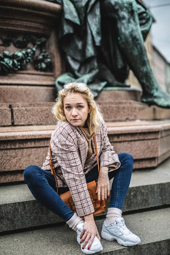 Woman in Brown Top Sitting on Stairs