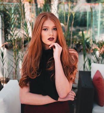 Woman in Brunette Hair Standing at Patio Furniture