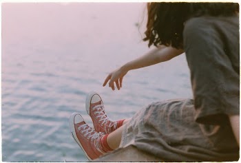 Woman in Casual Clothing Sitting by the Water