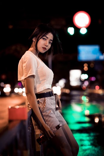 Woman In Casual Wear Drinking At Night