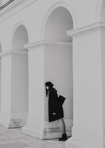 Woman in Coat Leaning Against Wall · Free Stock Photo