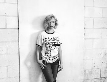 Woman in Crew-neck T-shirt and Pants Leaning on Wall