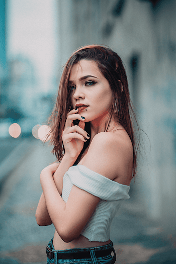 Woman in Crop-top With Right Hand on Lips