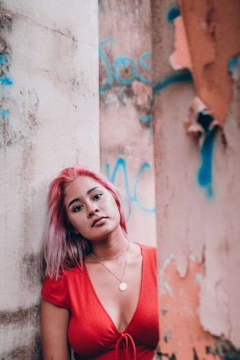 Woman in Deep V-neck Top Leaning on Wall