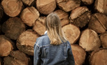 Woman In Denim Jacket in Front Logs