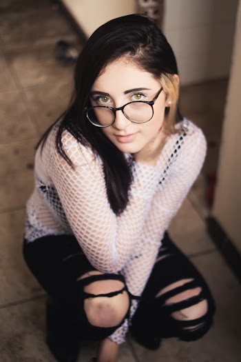 Woman in Distressed Black Jeans