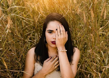 Woman in Dress Standing on Brown Grass