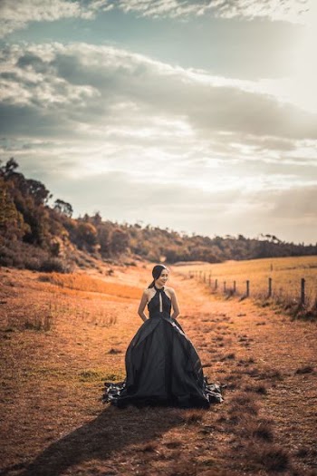 woman in dress standing on orange grass during daytime