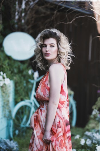 Woman in Floral dress posing for a photograph