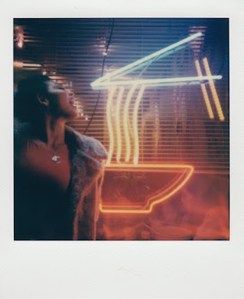 Woman in Front of Coffee Neon Sign