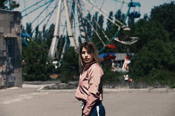 Woman in Front of Ferris Wheel
