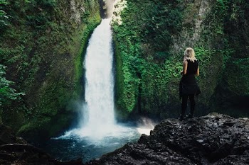 woman in front of waterfalls