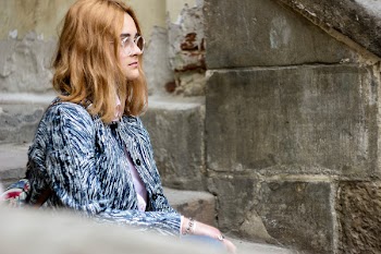 Woman in Gray and Black Top Sitting on Stairs