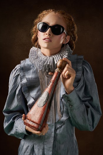 Woman in Gray Coat Holding Brown Wooden Stick