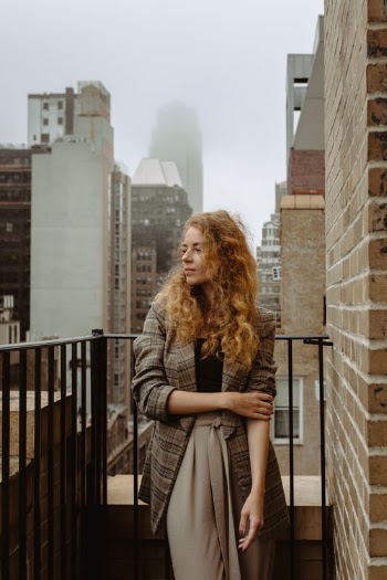 Woman in Gray Coat Standing on Brown Concrete Floor · Free Stock Photo