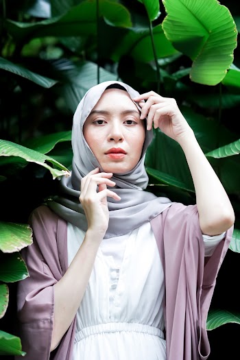 Woman in Gray Hijab Posing Near Green Plant