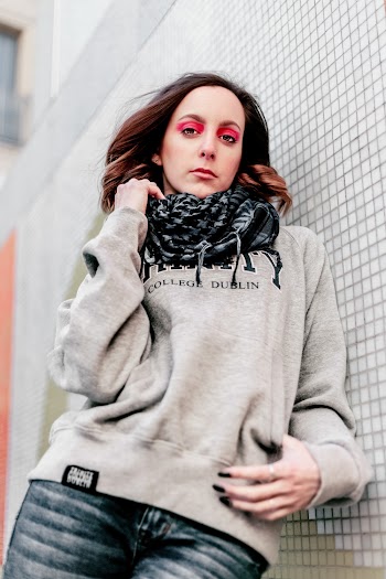 Woman in Gray Hoodie Leaning on Wall