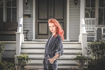 Woman in Gray Jumpsuit Standing in Front of House