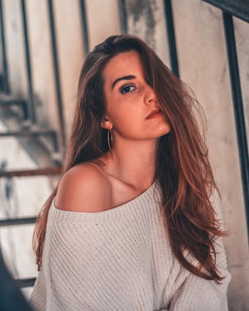 Woman in Gray Knitted Sweater Sitting on Stairs