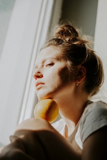 Woman in Gray Shirt Holding Yellow Fruit · Free Stock Photo