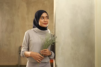 Woman in Gray Sweater Holding Flowers