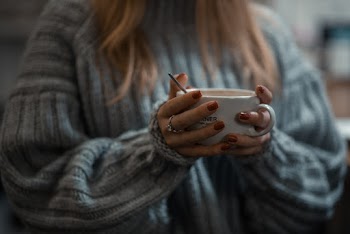 Woman in Gray Sweater Holding White Ceramic Mug