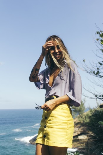 Woman in Gray Top Standing Beside Plants