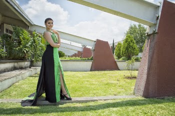 Woman in Green and Black Dress Standing in Front of Wall