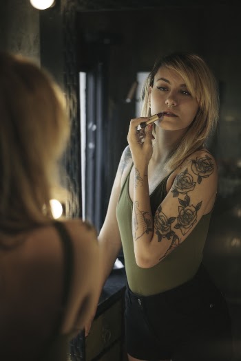 Woman In Green Camisole Top Holding Lipstick