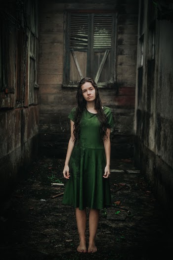 Woman in Green Dress Standing Outdoors