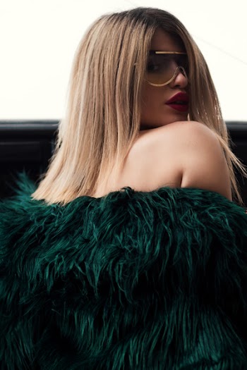 Woman in Green Fur Jacket Wearing Sunglasses With Gold Frame
