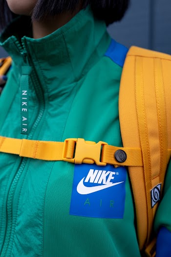 Woman in Green Jacket Carrying Backpack
