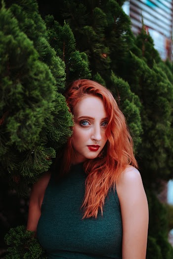 Woman In Green Sleeveless Shirt Standing Beside Bush