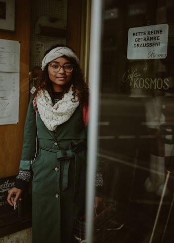 woman in green trench coat in shallow focus lens